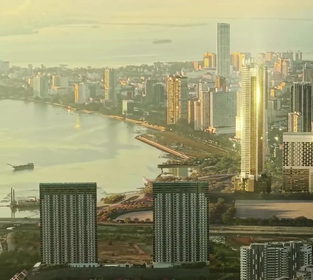 The tower rising above Gurney Bay and the George Town skyline at golden hour