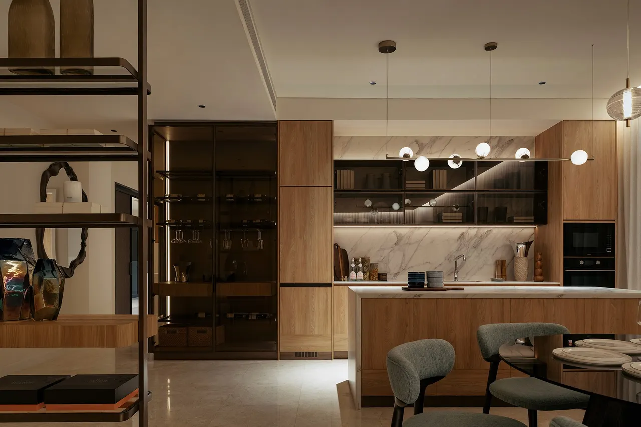 Dry kitchen and bar with glass display cabinetry and pendant lighting — show unit